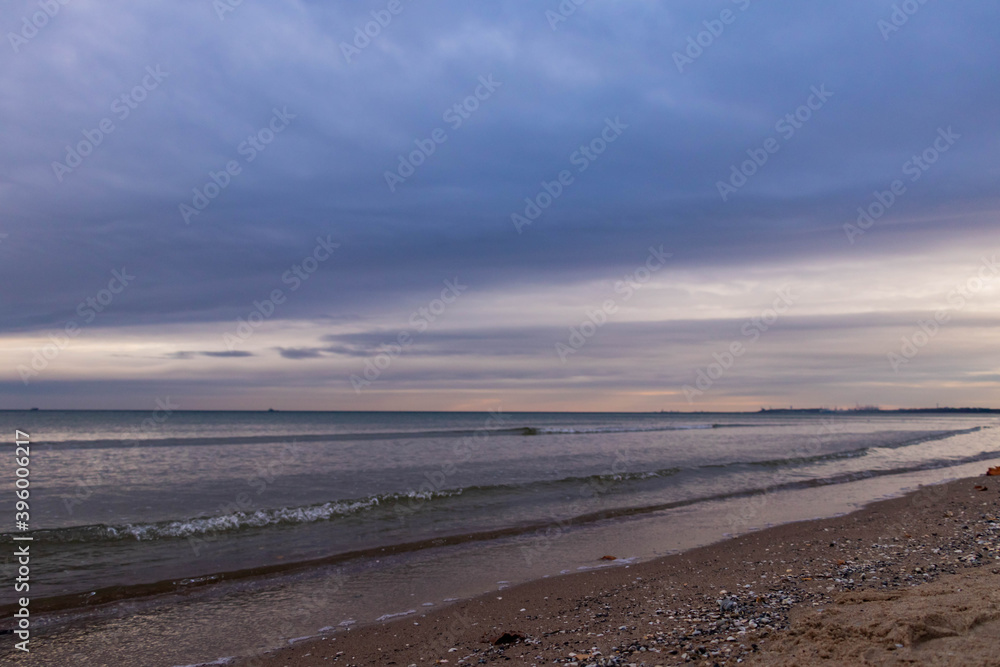 
beautiful calm sea waving in the early morning on a golden sandy beach