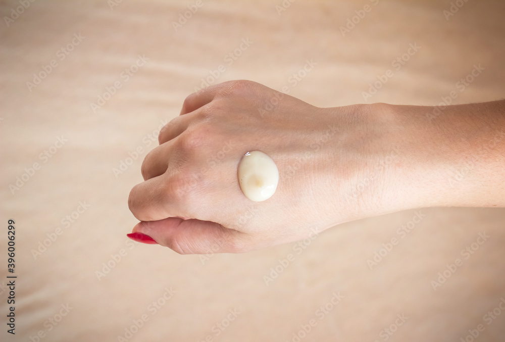 Cream on women's hands. Girl puts cream on her hands Cream on women's hands. Girl puts cream on her hands