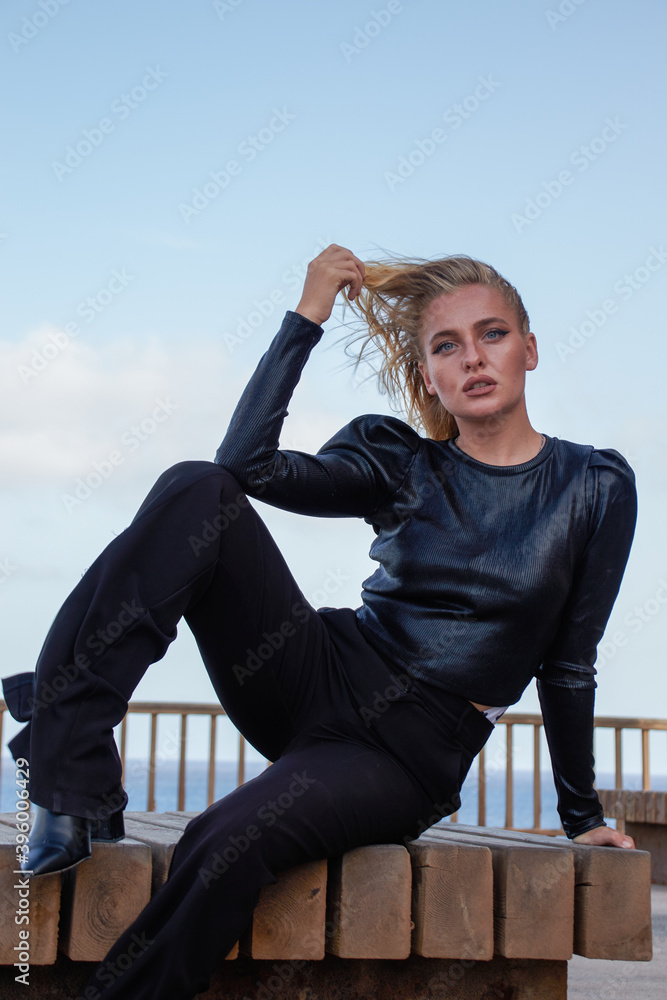 Blonde woman sitting near the sea Blonde woman sitting near the sea