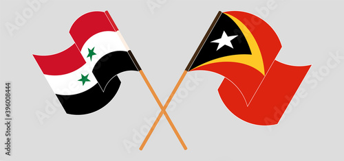 Crossed and waving flags of East Timor and Syria