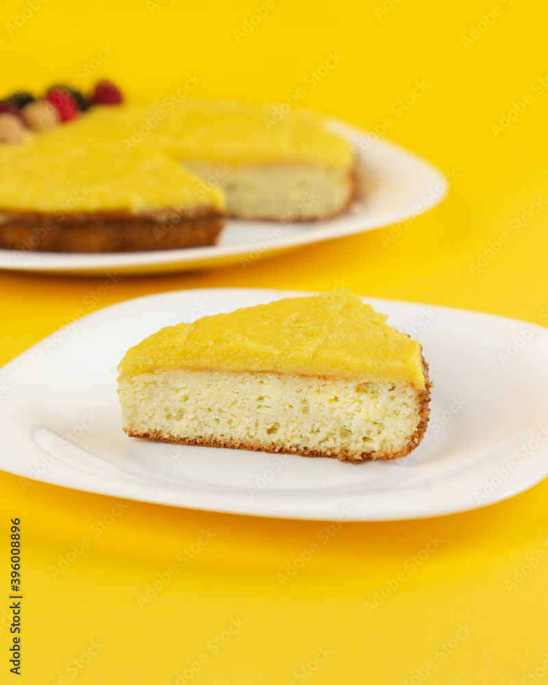 Traditional Filipino dessert - Yema cake. Homemade baking. Chiffon sponge cake with custard and cheese. Minimalist composition on a yellow background. Traditional Filipino dessert - Yema cake. Homemade baking. Chiffon sponge cake with custard and cheese. Minimalist composition on a yellow background.