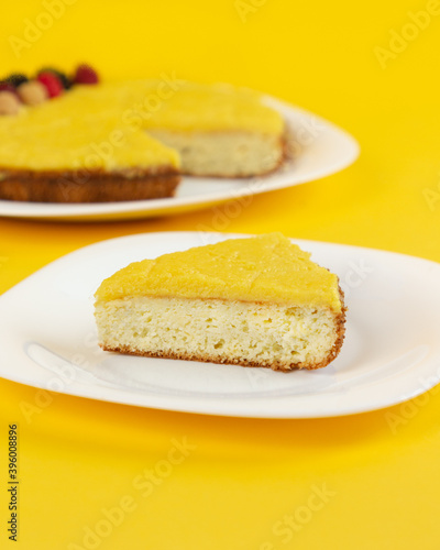 Traditional Filipino dessert - Yema cake. Homemade baking. Chiffon sponge cake with custard and cheese. Minimalist composition on a yellow background.