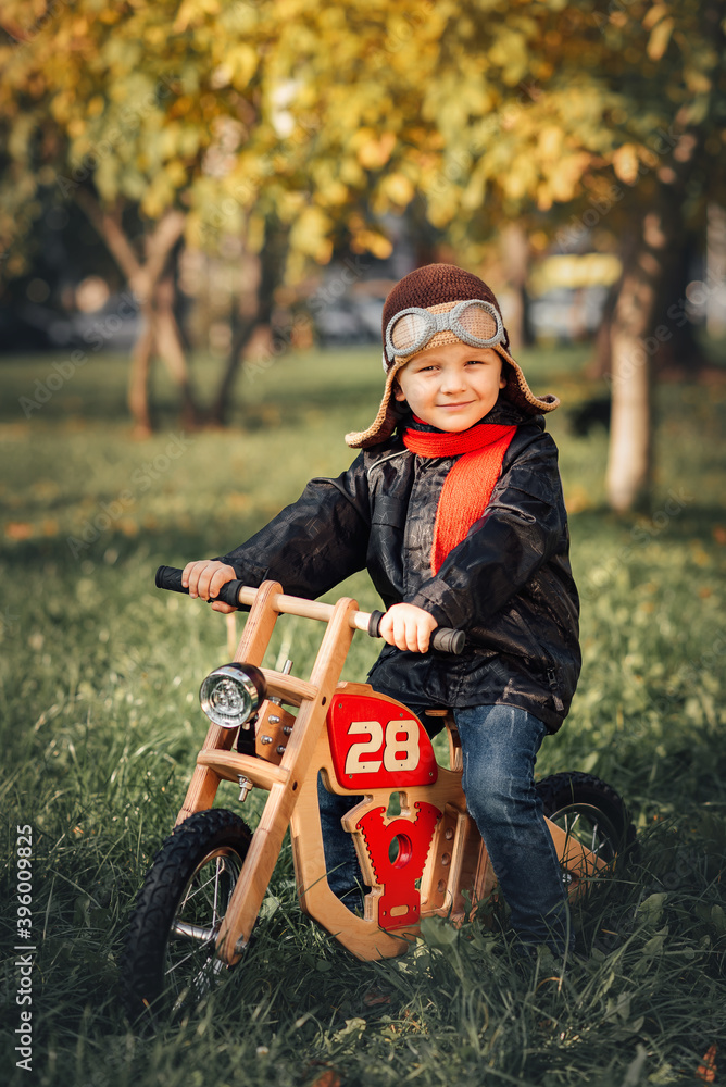 small child sits on a balance bike in outerwear small child sits on a balance bike in outerwear