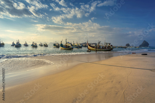 Jember, East Java / Indonesia - 05 25 2017: Fishermen return to shore with their catch at Tanjung Papuma beach, Jember, East Java photo