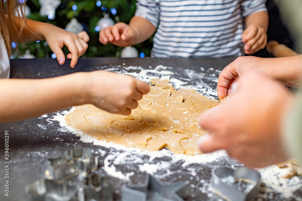 christmas and new year holidays, mom and children prepare gingerbread cookies christmas and new year holidays, mom and children prepare gingerbread cookies