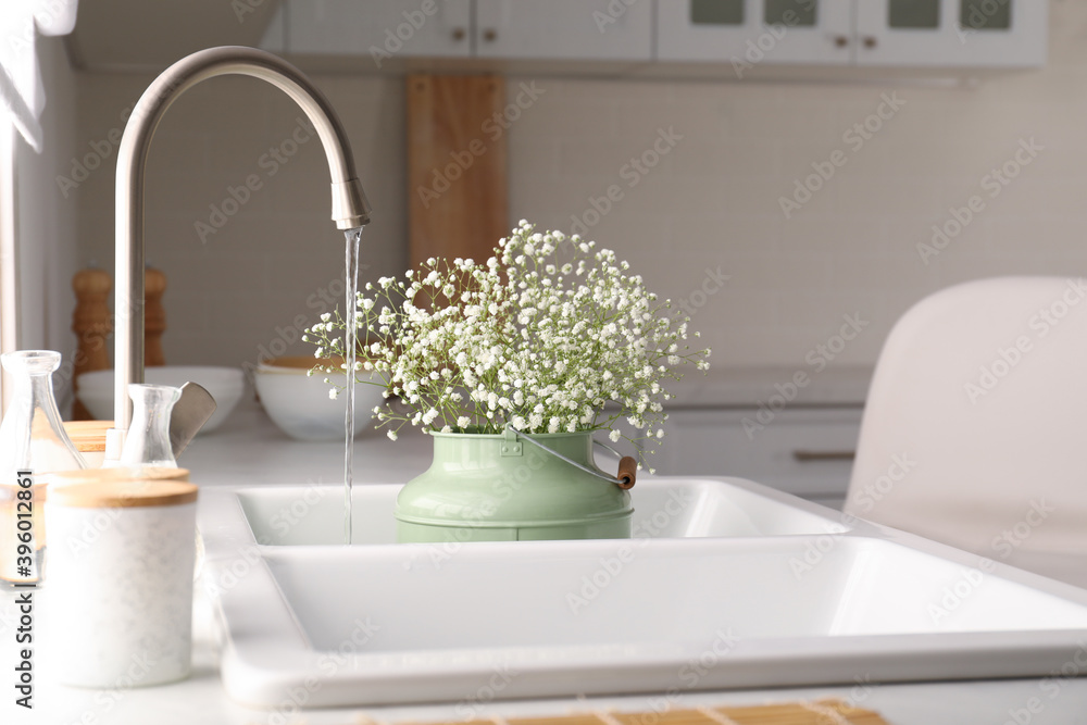 Bouquet of gypsophila flowers in sink. Kitchen interior design Bouquet of gypsophila flowers in sink. Kitchen interior design