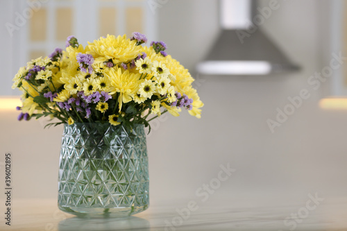 Wallpaper Mural Vase with beautiful chrysanthemum flowers on table in kitchen, space for text. Interior design Torontodigital.ca