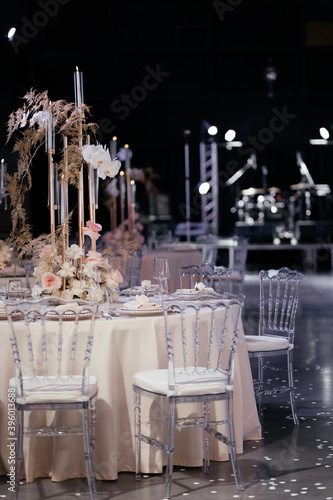 Wedding dining table decorated with flowers and candles. Place for guest on the wedding. Wedding tavle setting. Wedding banquet photo