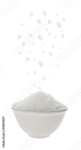 Salt falling into bowl on white background