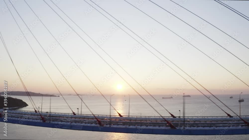 Flying sideways along the empty road of the Russian Bridge. There is no traffic as the bridge is covered with ice after the severe storm. Morning. Russia, Vladivostok Flying sideways along the empty road of the Russian Bridge. There is no traffic as the bridge is covered with ice after the severe storm. Morning. Russia, Vladivostok