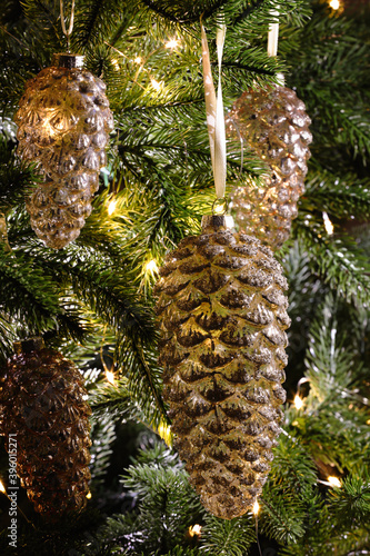 Christmas tree decorated with holiday baubles and fairy lights, closeup