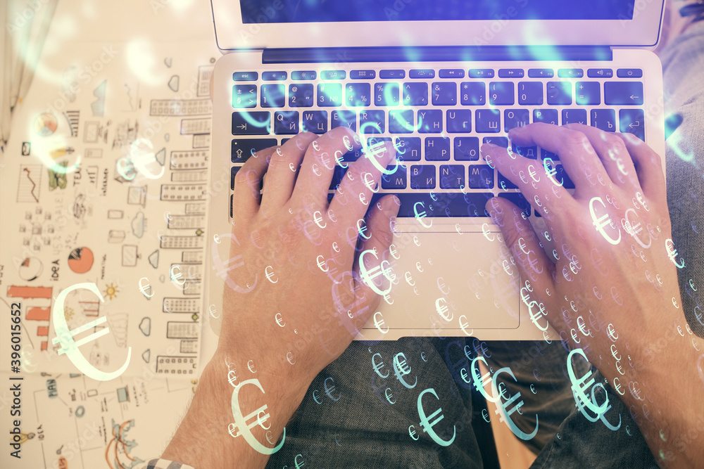 Double exposure of man's hands typing over laptop keyboard and forex chart hologram drawing. Top view. Financial markets concept. Double exposure of man's hands typing over laptop keyboard and forex chart hologram drawing. Top view. Financial markets concept.