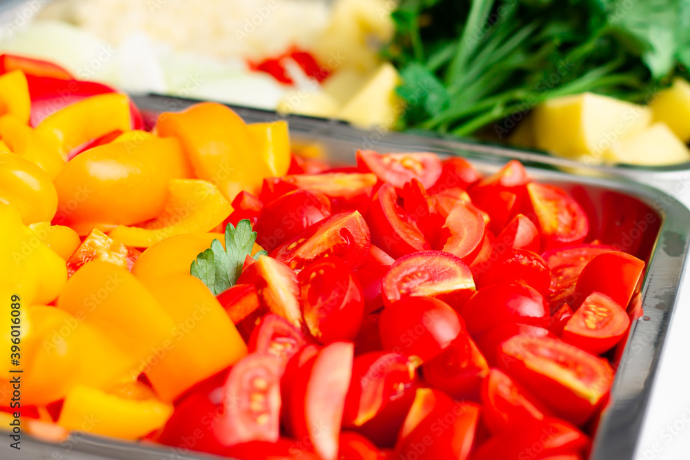 Chopped ingredients for making oriental vegetable stew. Paprika, potatoes, onions, tomatoes, garlic, peppers, spices. Chopped ingredients for making oriental vegetable stew. Paprika, potatoes, onions, tomatoes, garlic, peppers, spices.