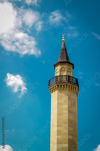 The minaret of the Muslim mosque against the background of the cloudy sky. minaret directed to the sky. Kiev, Ukraine. Ar-rahma mosque 