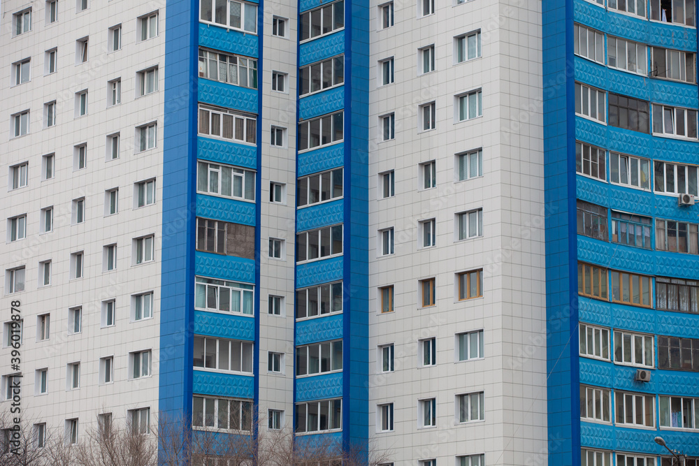 Fototapeta premium Autumn, 2013 - Vladivostok, Primorsky region - High-rise residential buildings. Multi-colored residential buildings. Windows in residential high-rise buildings.