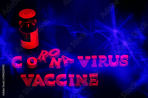 Vial with vaccine on black and blue background, 3d text corona virus vaccine