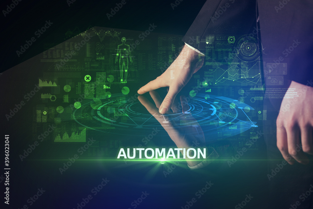 Businessman touching huge display with AUTOMATION inscription, modern technology concept Businessman touching huge display with AUTOMATION inscription, modern technology concept