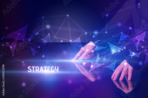 Businessman touching huge screen with STRATEGY inscription, modern technology business concept