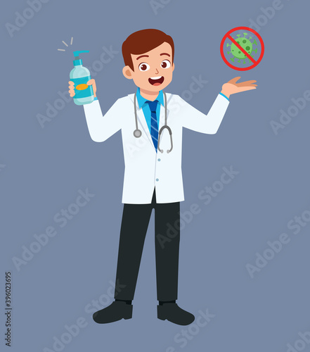 nice good looking young doctor standing and holding hand sanitizer
