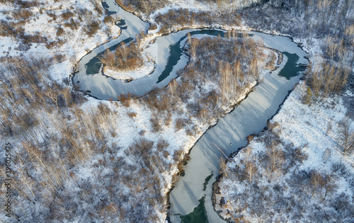Aerial photo of Koen river under ice and snow. Beautiful winter landscape.