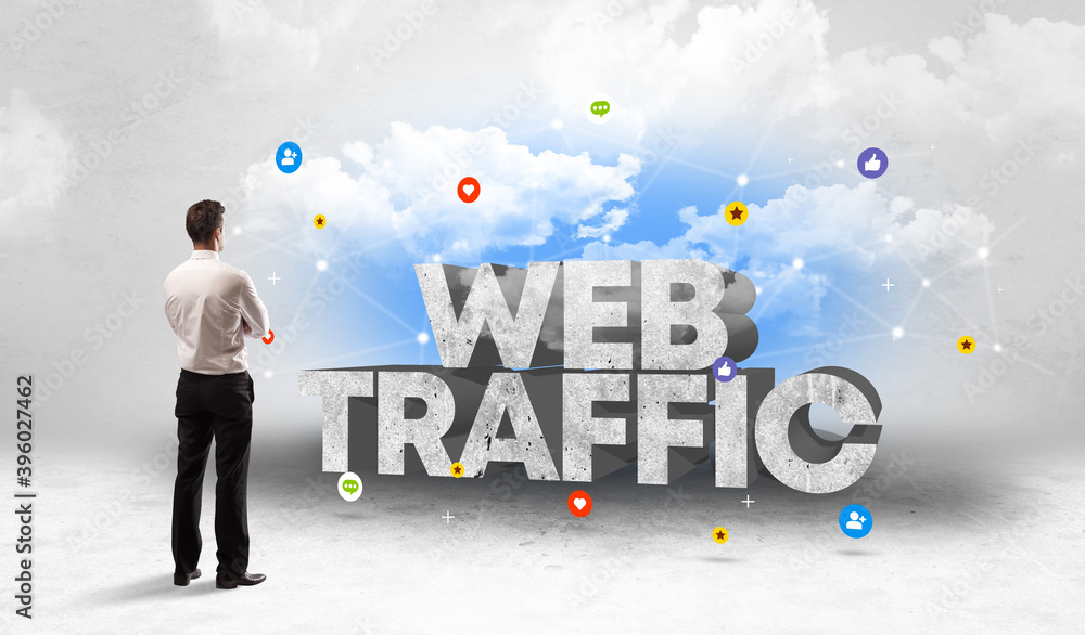 Young businessman standing in front of WEB TRAFFIC inscription, social media concept Young businessman standing in front of WEB TRAFFIC inscription, social media concept