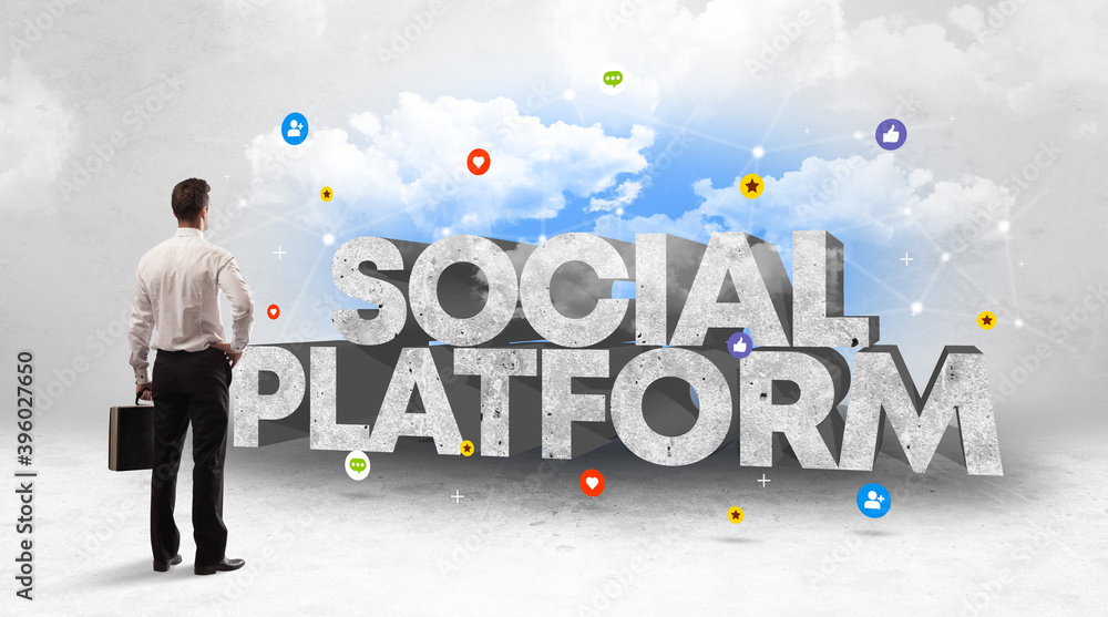 Young businessman standing in front of SOCIAL PLATFORM inscription, social media concept Young businessman standing in front of SOCIAL PLATFORM inscription, social media concept