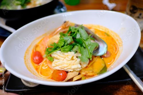 Dish of spaghetti with shrimp and spicy Tom Yum sauce with Thai herbs
