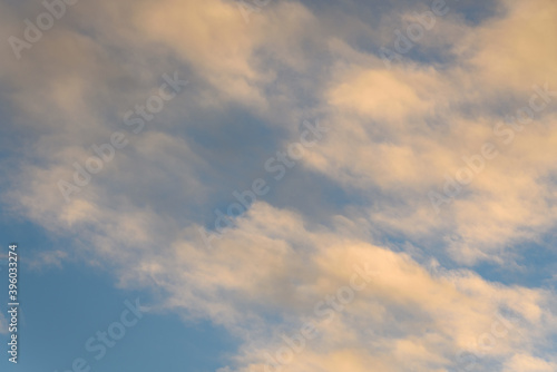 Fototapeta Naklejka Na Ścianę i Meble -  Peaceful evening light on white clouds and blue sky, as a nature background
