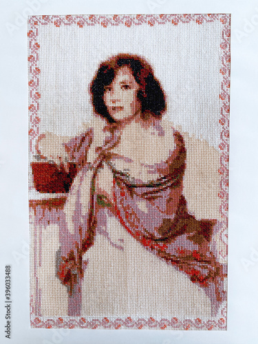 cross stitch beautiful woman at the table with a book