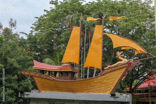 ship monument with dragon carving in asia. tugu kapal lancang kuning photo