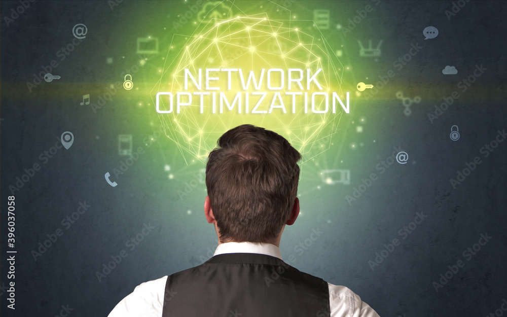 Rear view of a businessman with NETWORK OPTIMIZATION inscription, online security concept Rear view of a businessman with NETWORK OPTIMIZATION inscription, online security concept