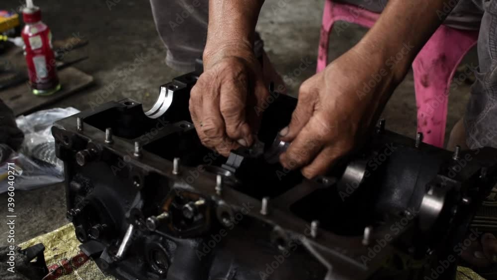 Car engine repair technician assembling connecting rod journal bearing Car engine repair technician assembling connecting rod journal bearing