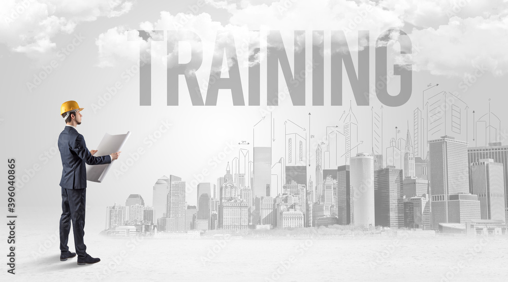 Young businessman with hard hat and TRAINING inscription, new business opportunity concept Young businessman with hard hat and TRAINING inscription, new business opportunity concept