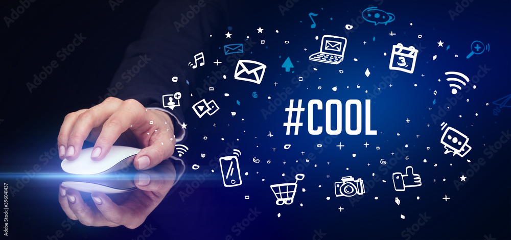 hand holding wireless peripheral with #COOL inscription, social media concept hand holding wireless peripheral with #COOL inscription, social media concept