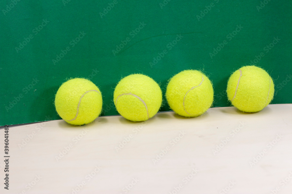 Tennis balls are on green grass