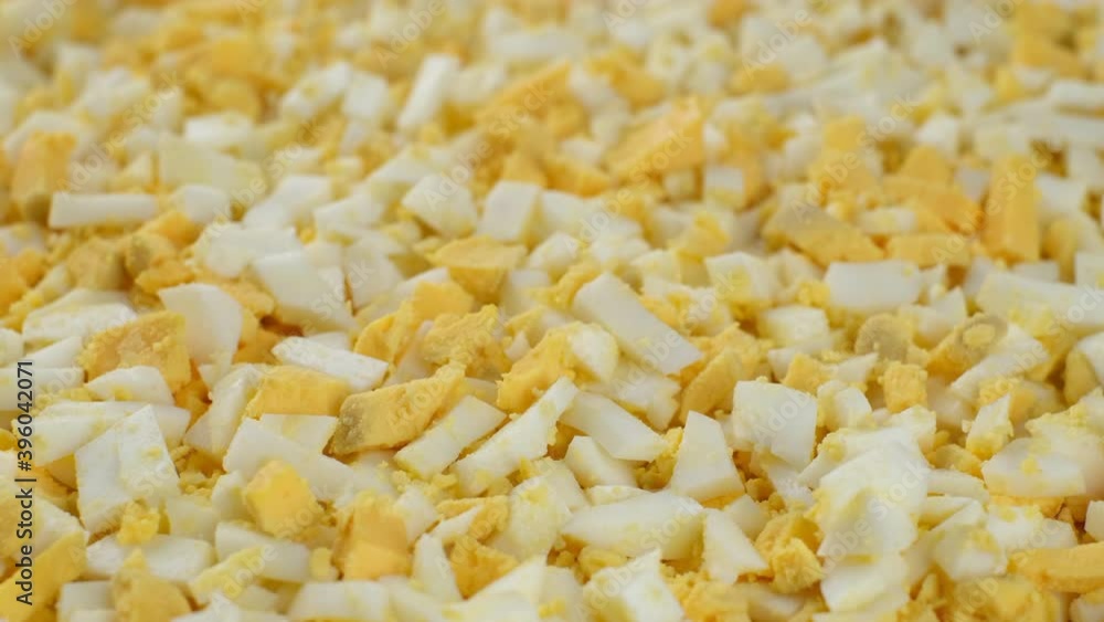 chopped boiled eggs top view rotating. chopped eggs for Olivier salad chopped boiled eggs top view rotating. chopped eggs for Olivier salad