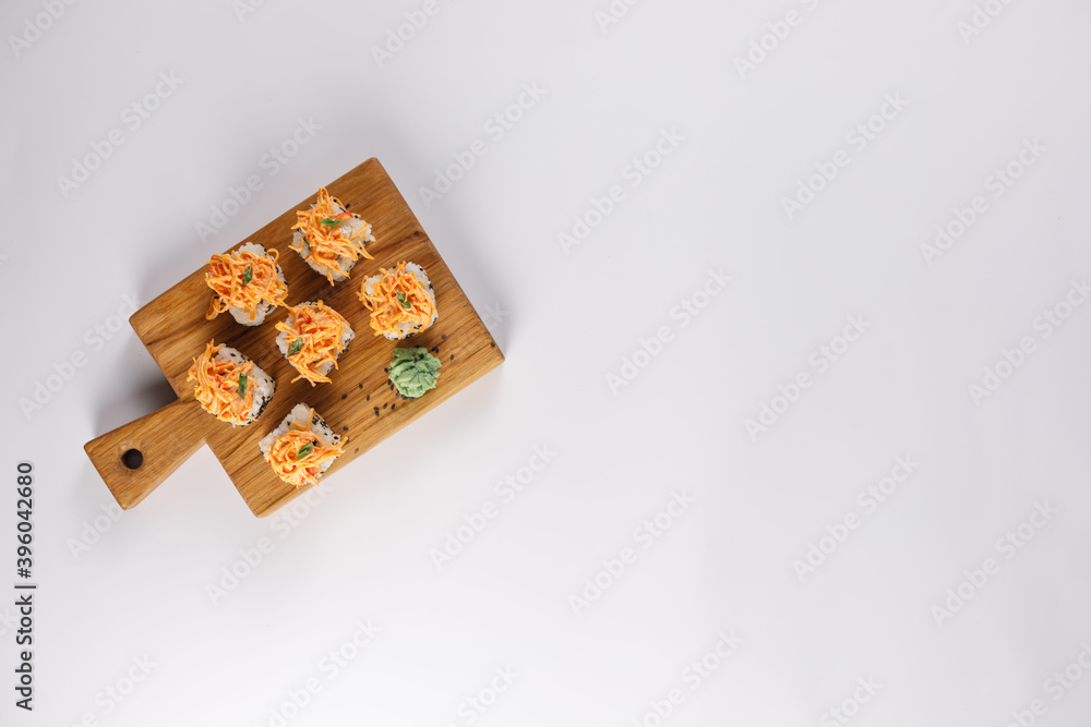 Appetizing rolls on a white background. Japanese food concept. Close-up. Copy space. Flat lay. Appetizing rolls on a white background. Japanese food concept. Close-up. Copy space. Flat lay.