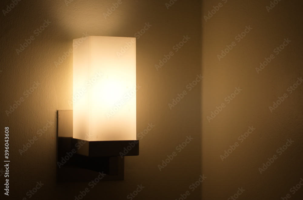 Sleeping head lamp. Lamp shines with light on the wall. Warm lighting.