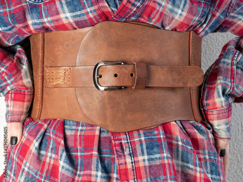 Women leather wide belt of brown color with buckle