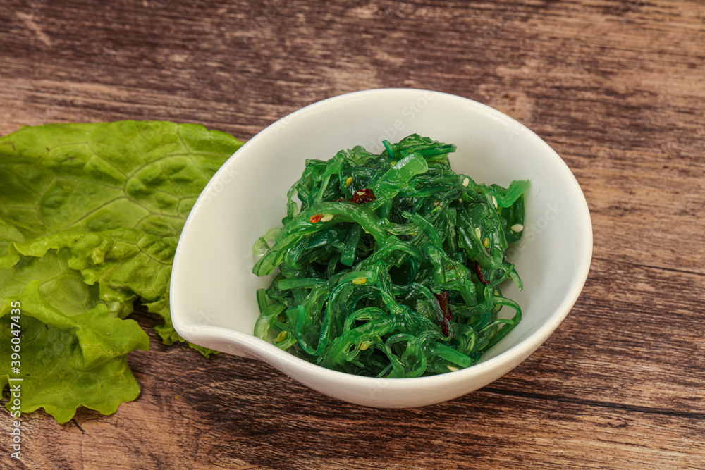 Green Chuka Seaweed Salad Isolated on White Background Top View. Wakame Sea Kelp Salat Green Chuka Seaweed Salad Isolated on White Background Top View. Wakame Sea Kelp Salat