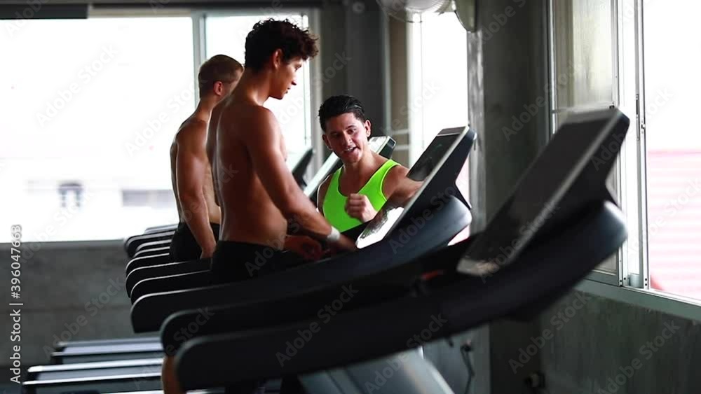 Group young peoples running on a treadmill in health club. Side view. Group young peoples running on a treadmill in health club. Side view.