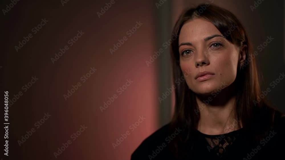 young woman with sensual face is sitting in studio and posing seriously young woman with sensual face is sitting in studio and posing seriously