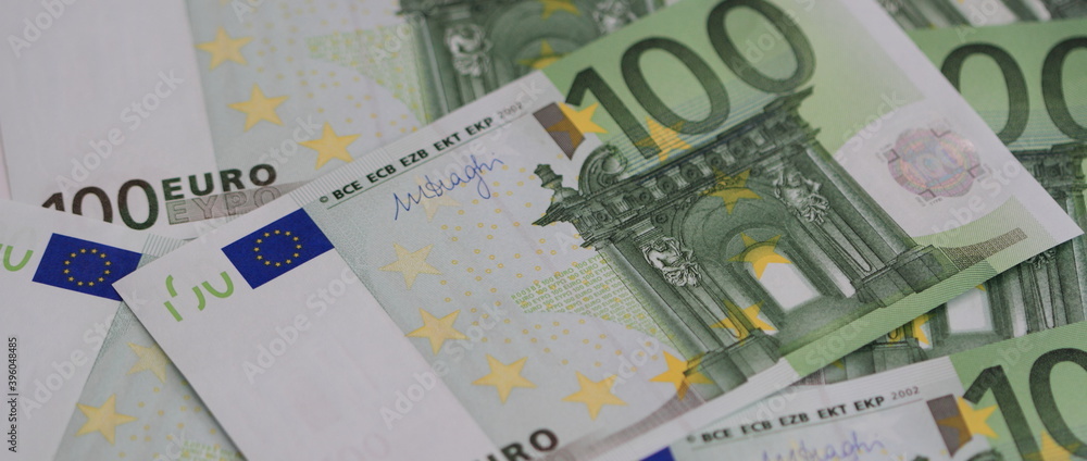 many 100 euro banknotes on a table many 100 euro banknotes on a table