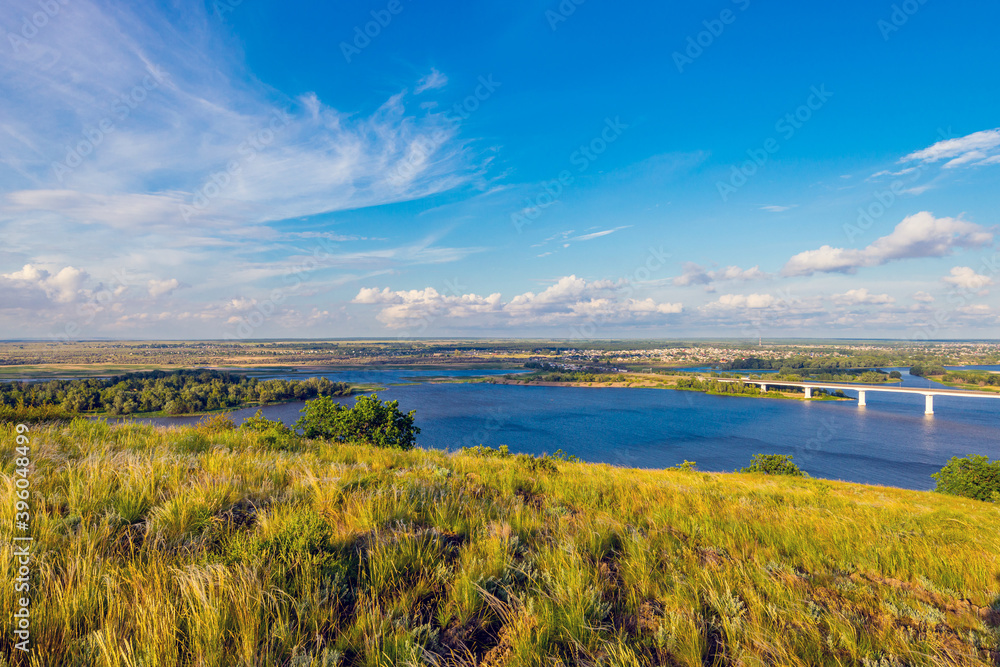 Panoramic view of the road bridge over big river and hills, slopes, steppe coast, gully, ravine on a banks