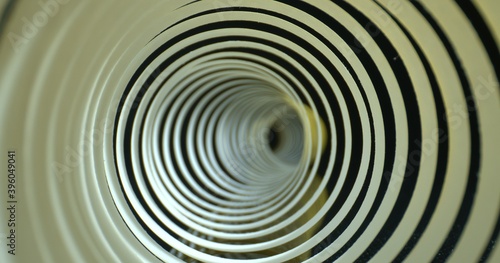Abstract tunnel shot. Spiral made of paper with soft shadows. Close-up inside spiral paper tape. High quality.