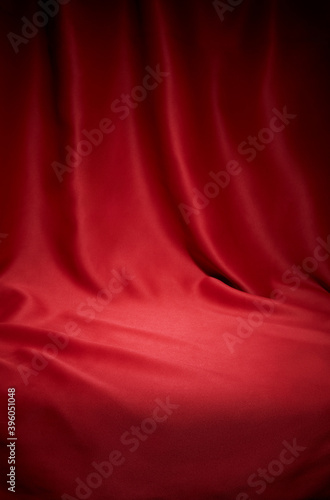 Red cloth waves texture background stage shot in table top for christmas background 