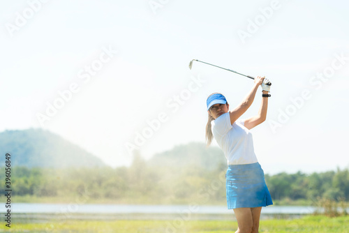 Golfer woman chip golf ball out of a sand trap. People swing and hitting golf course is on the fairway. Hobby in holiday and vacations on club golf.
