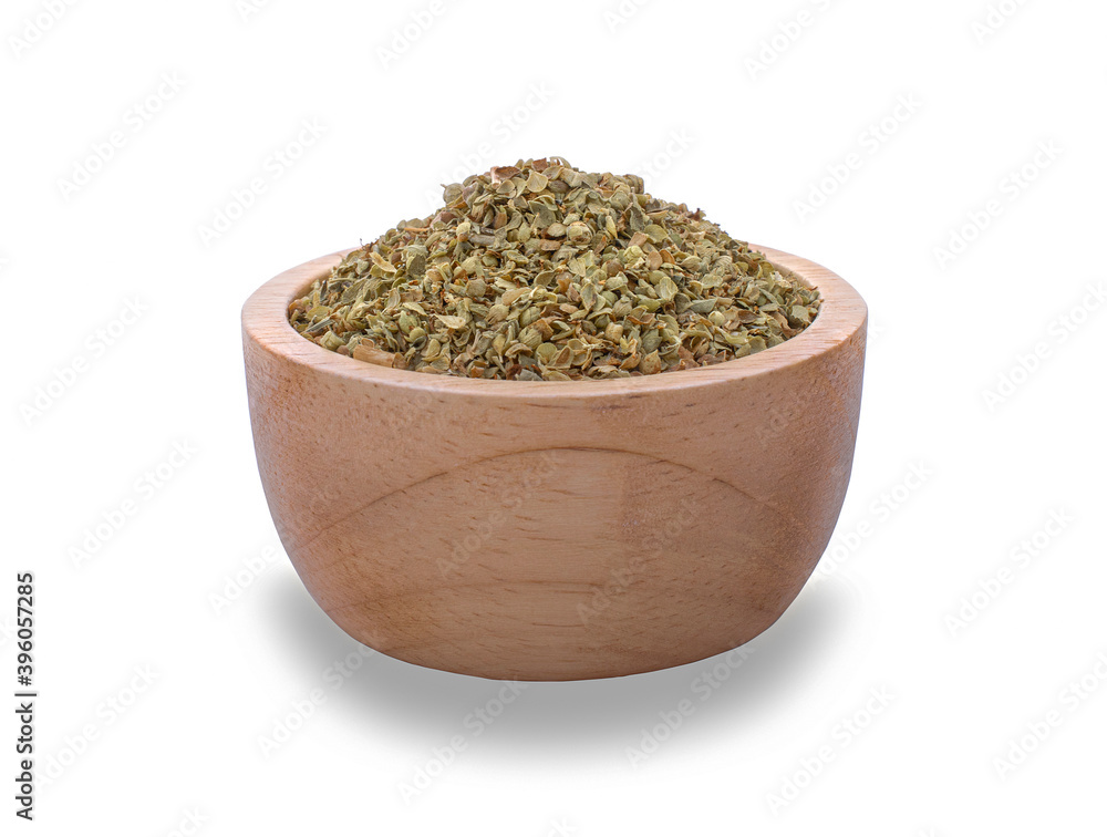 Dried oregano seasoning in a wooden bowl isolated on white background.. Dried oregano seasoning in a wooden bowl isolated on white background..