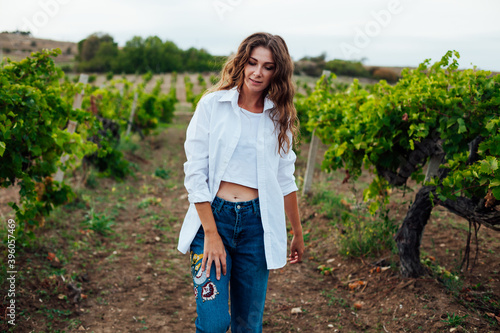 beautiful fashionable woman in the vineyards for wine