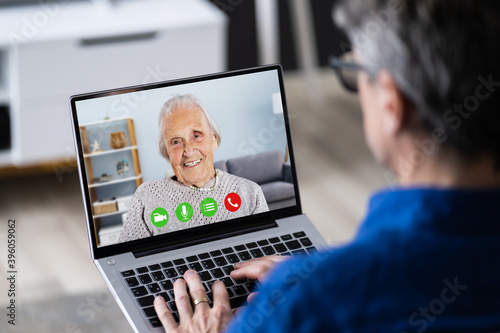 Elderly Man Video Conferencing With Mother